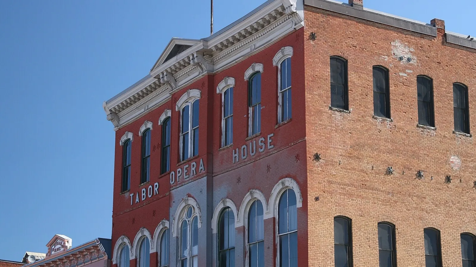 The red-brick Tabor Opera House on Harrison Avenue in Leadville, its name painted across the front, in June 2010